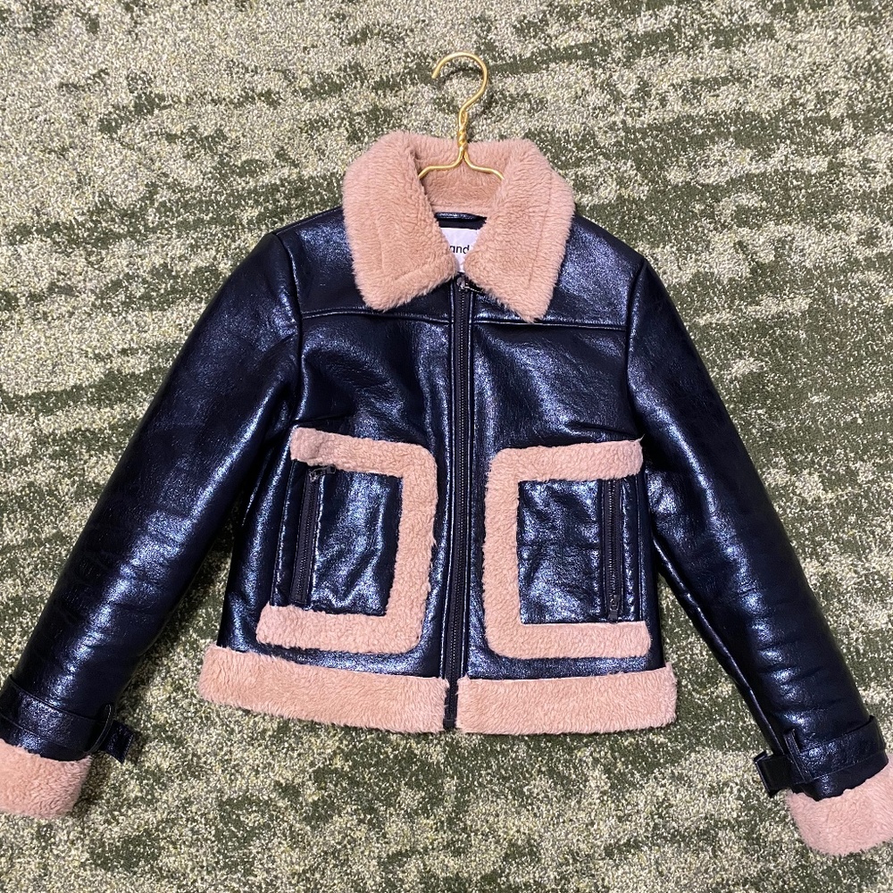 STAND women’s black patent leather jacket with beige fur trim